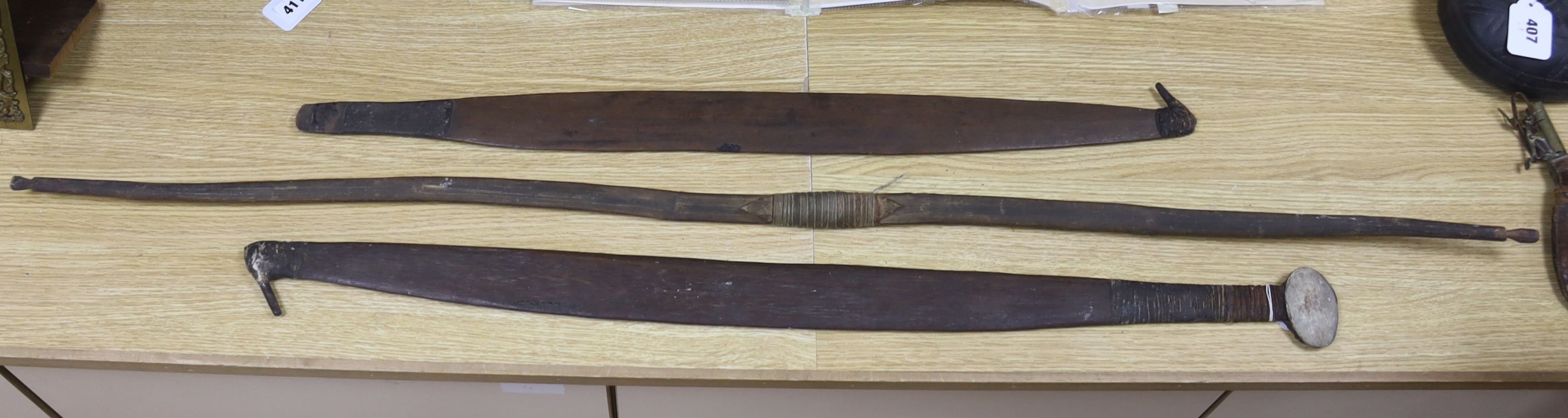 Two chip-carved paddle blades and bow, possibly Fijian.